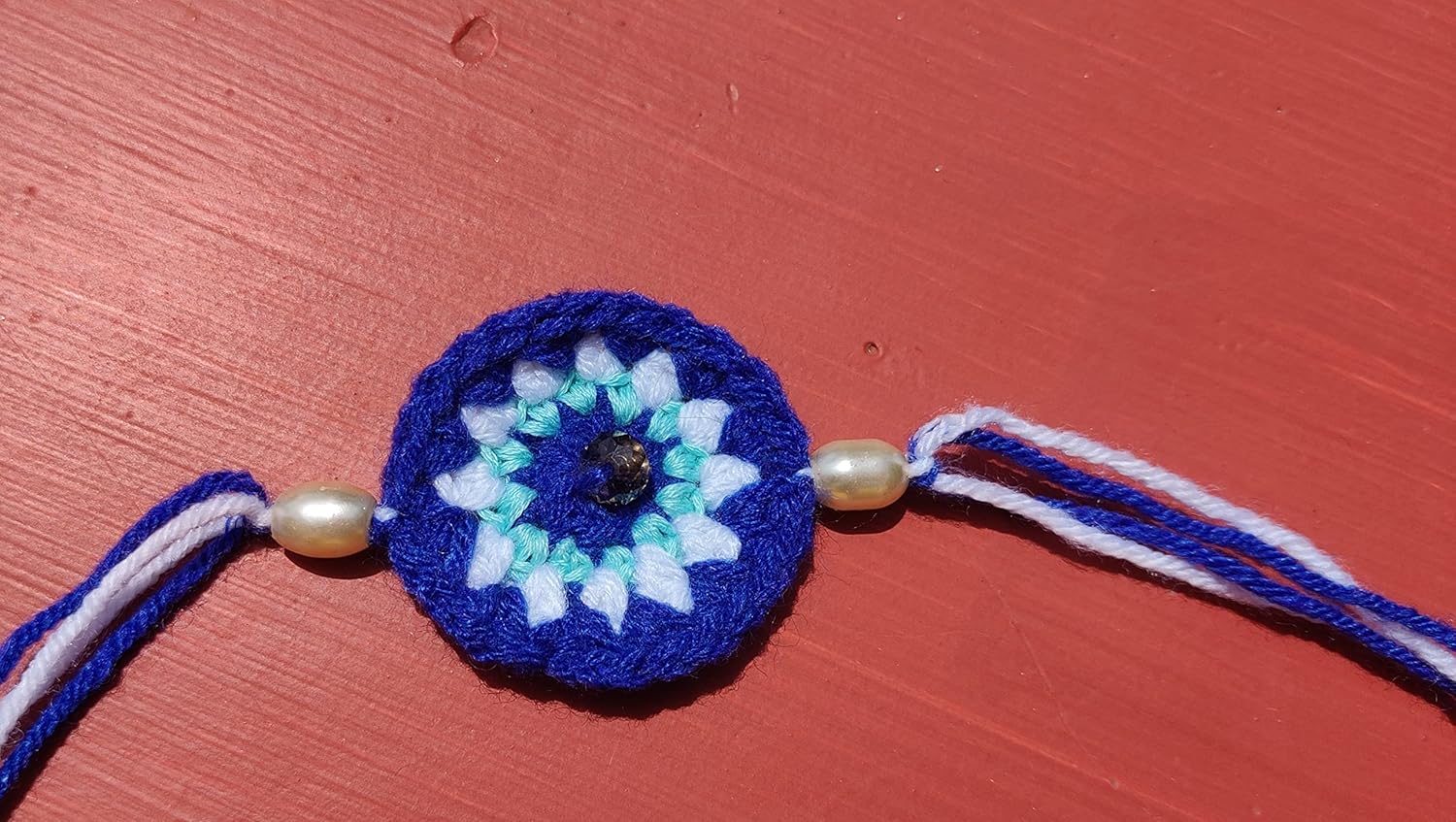 Kids multicolor evil eye, car and teddy rakhi set of 3 crochet rakhi bhaiya bhabhi rakhi gift set for rakhsha bandhan combo set with packed in fabric pouch with roli kumkum and chawal. Color may vary - Image 4