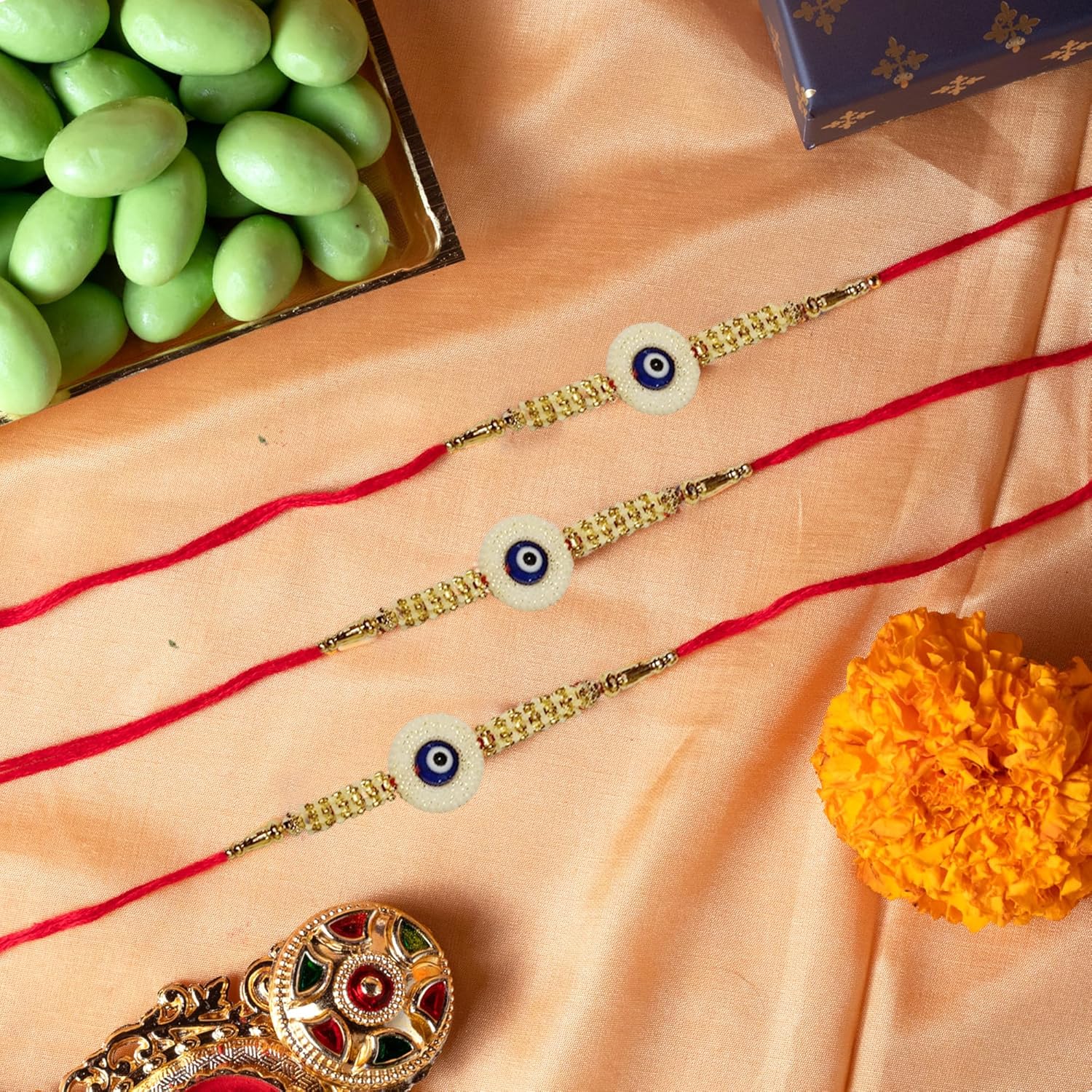 Oriole Gifts Rakhi Hamper for Brother with Premium Evil Eye Rakhi, Chocolate Bites, Almond Brittles, Coffee Almond Nutties, Paan Shots, Snacks & Greeting Card | Rakshabandhan Gift for Brother with Chocolate Gift Box - Image 5