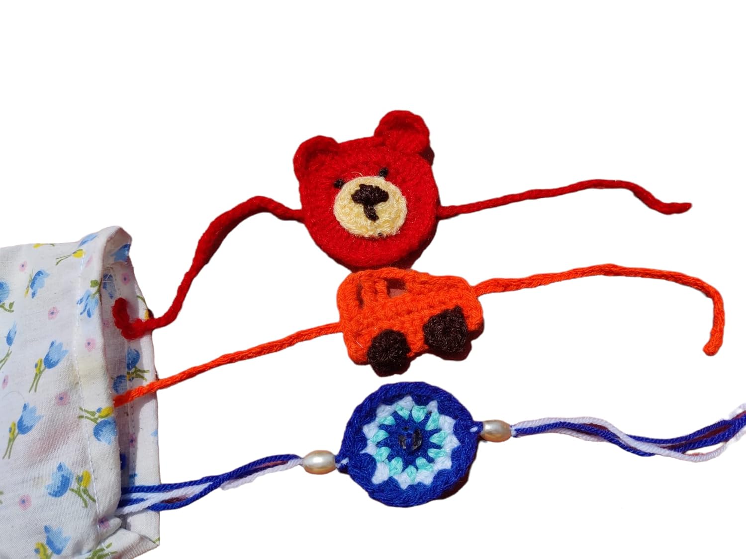 Kids multicolor evil eye, car and teddy rakhi set of 3 crochet rakhi bhaiya bhabhi rakhi gift set for rakhsha bandhan combo set with packed in fabric pouch with roli kumkum and chawal. Color may vary - Image 2