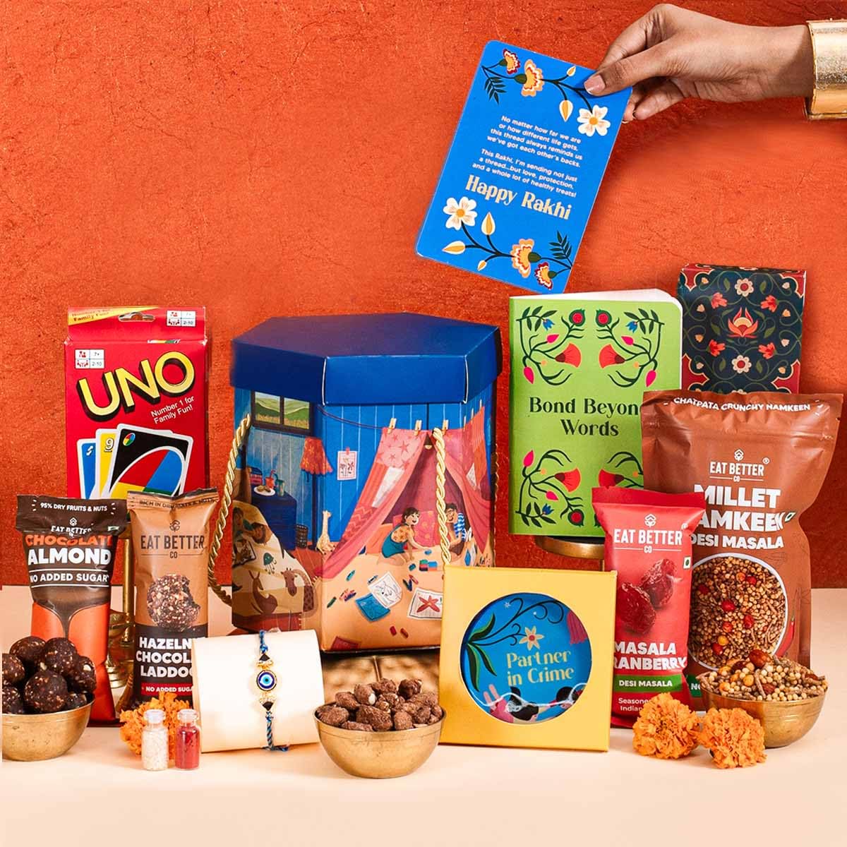 Yaadon Ka Dabba – 10-Item Rakhi Hamper for Brother – Evil Eye Rakhi, Chocolate Coated Almonds, Hazelnut Dry-Fruit Laddoos, Uno & More | Chocolates & Sweets for Brother – Gift Combo Set - Image 2