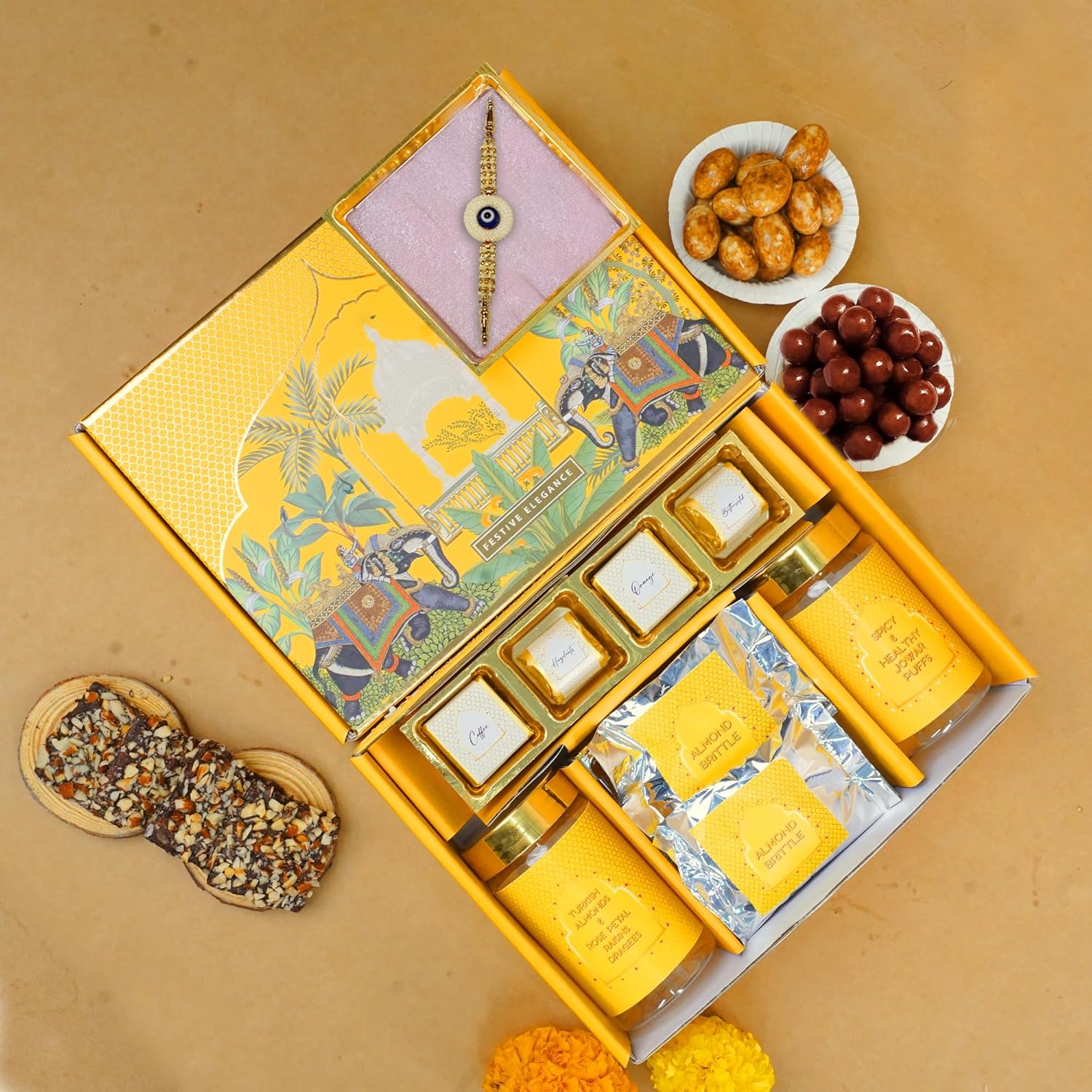 Oriole Gifts Rakhi Hamper for Brother with Premium Evil Eye Rakhi, Chocolate Bites, Almond Brittles, Coffee Almond Nutties, Paan Shots, Snacks & Greeting Card | Rakshabandhan Gift for Brother with Chocolate Gift Box - Image 4