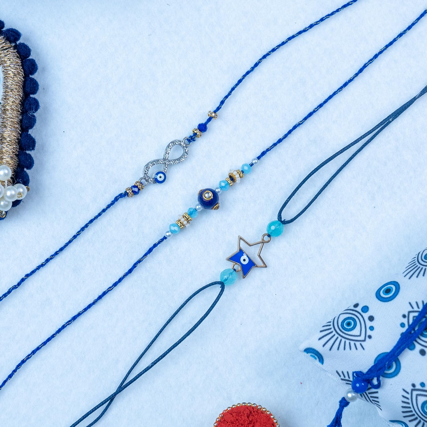 MyPoojaThali Set of 3 Evil Eye Rakhi for Brother with Thali, Blessing Card, Roli Chawal & Printed Gift Pouch – Designer Raksha Bandhan Combo - Image 3