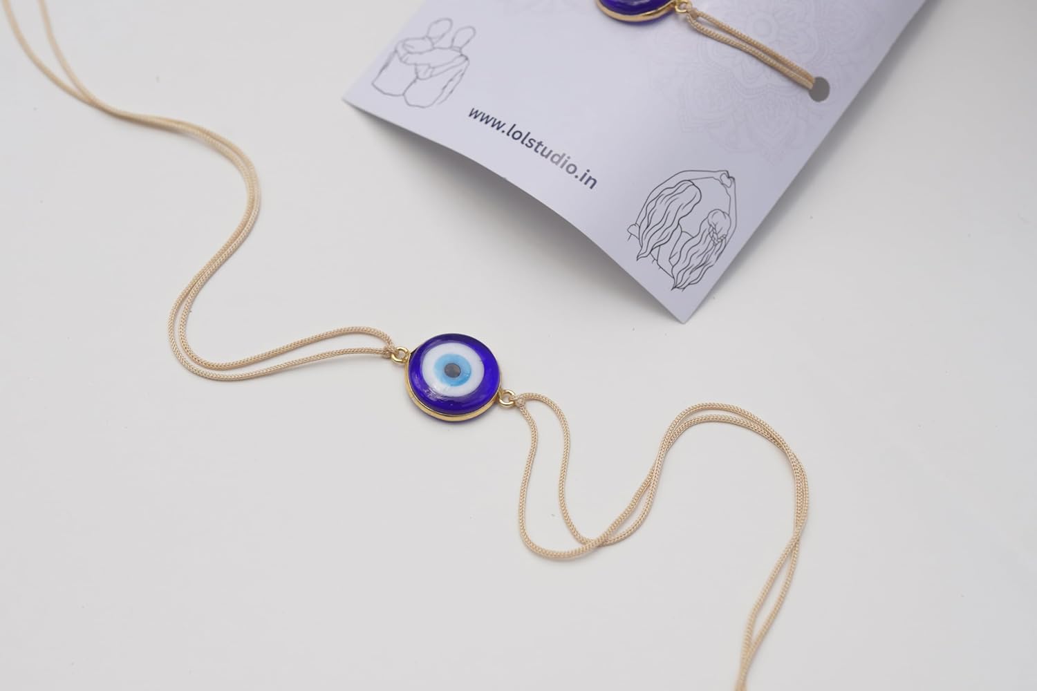 LOL STUDIO - LIVE OUT LOUD Evil Eye Rakhi with Blue Glass Pendant, Gold-Toned - Image 4
