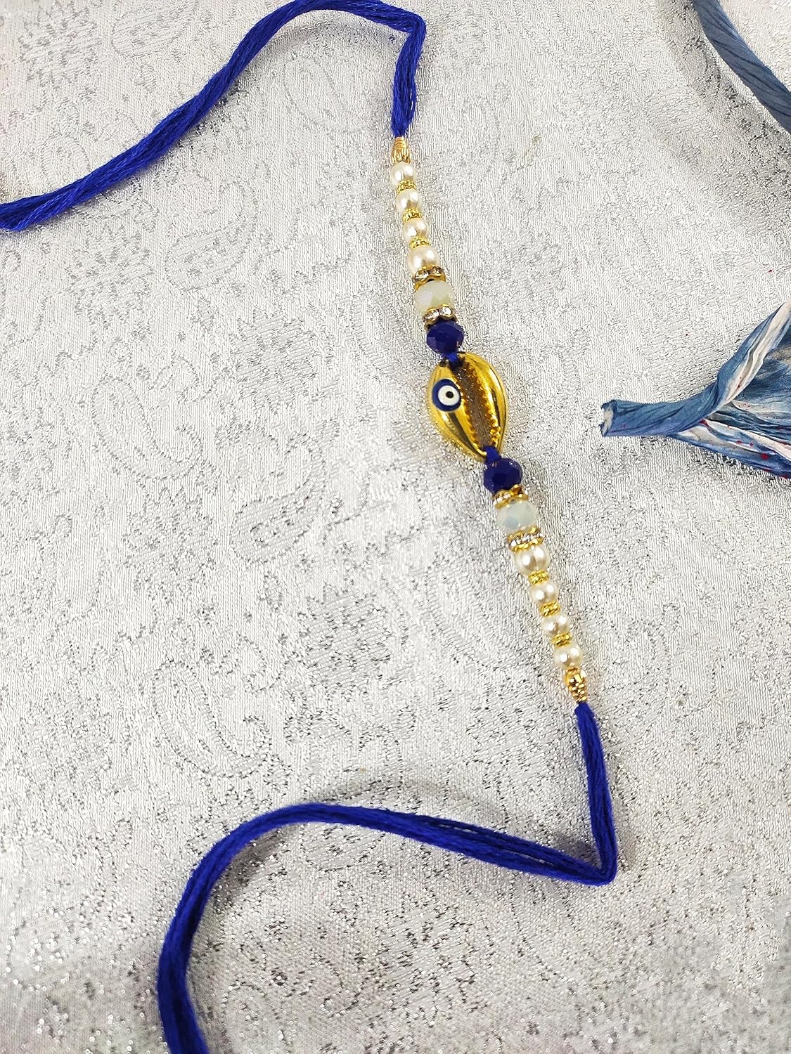 SAFFRON SHADES Sign of Prosperity Cowrie Shell Red and Blue Evil Eye Rakhi for Brother | Designer Premium Rakhi | Roli Chawal - Image 4